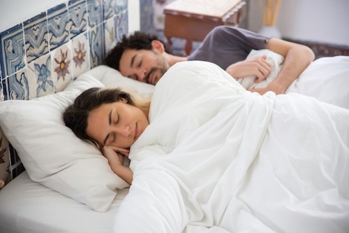 Couple sleeping in bed