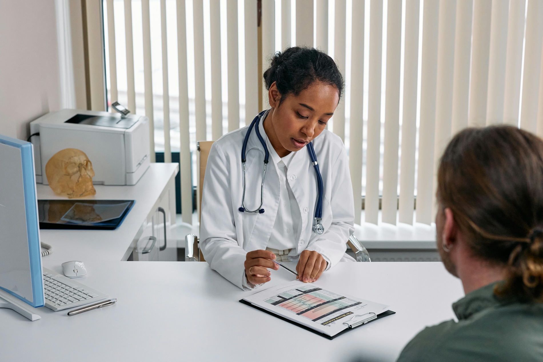 Doctor filling out paperwork with a patient